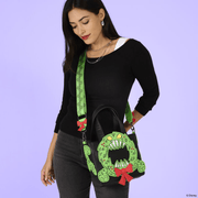 Model wearing Loungefly Nightmare Before Christmas Man-Eating Wreath Mini Tote Crossbody Bag with bright green patterned strap