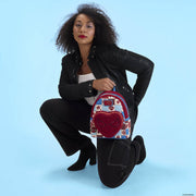 Model holding Loungefly Spider-Man mini backpack with plush heart pocket, studio shot.