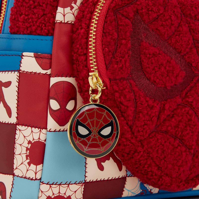 Close-up of Spider-Man face zip charm and textured heart pocket on Loungefly mini backpack.