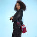 Model wearing Loungefly Spider-Man sherpa phone crossbody with blue strap and coin pouch.