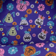 Close-up of purple lining with pumpkin-style Disney character faces and candy print inside the Loungefly backpack