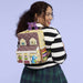 Model wearing Loungefly Monsters University scare house mini backpack on back
