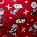 Close-up of red printed lining with Snoopy, hearts and XO pattern inside the Loungefly Peanuts mini backpack