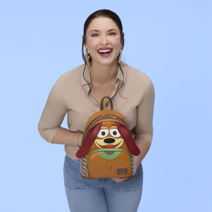 Model holding Loungefly Pixar Toy Story Slinky Dog cosplay mini backpack