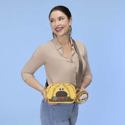 Model wearing the Loungefly Pixar Up Dug Sling Crossbody Bag with detachable character coin purse