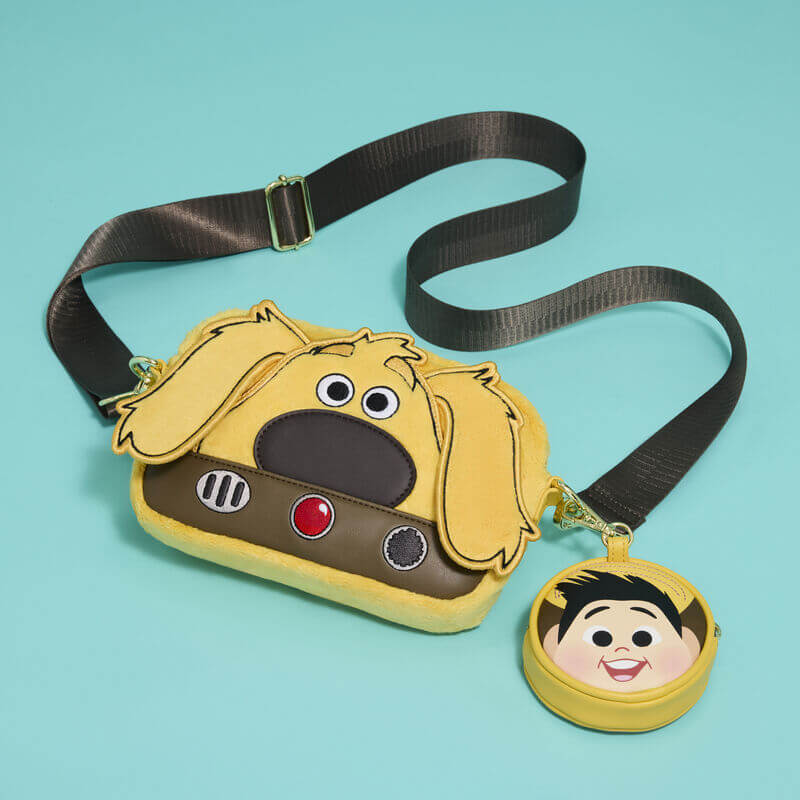 Loungefly Pixar Up Dug Sling Crossbody Bag laid flat with adjustable strap and detachable Russell coin purse