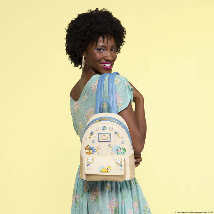 Lifestyle image of the Loungefly Pokémon Floral Mini Backpack showing the cream floral design with Pikachu, Eevee and Bulbasaur