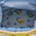 Interior lining detail of the Loungefly Pokémon Floral Pikachu Crossbody Bag with Pikachu, Eevee and Bulbasaur among blue and white flowers