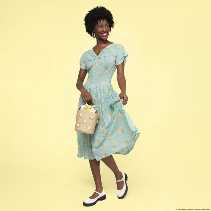 Model wearing the Loungefly Pokémon Floral Pikachu Crossbody Bag featuring a floral design and Pikachu character detail