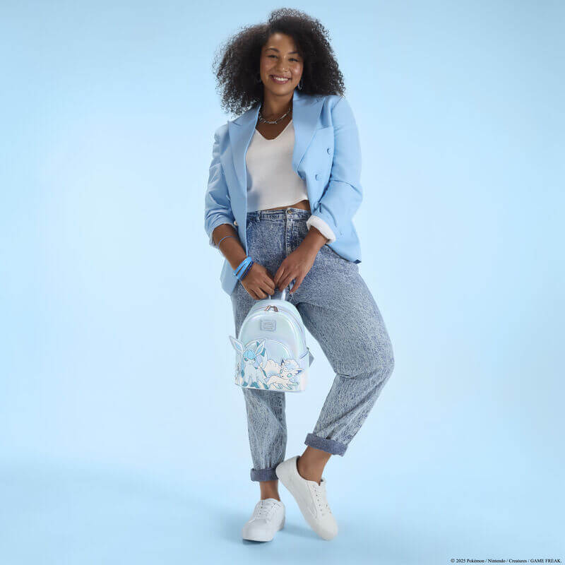 Model holding the Loungefly Pokémon Ice Type Winter mini backpack, showing the iridescent finish and character appliqué.