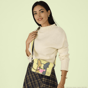 Model wearing the Loungefly Morpeko Reversible Crossbody Bag showing yellow Full Belly Mode and magnetic strawberry charm