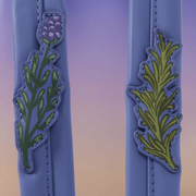 Botanical appliqué details on Practical Magic Loungefly backpack straps