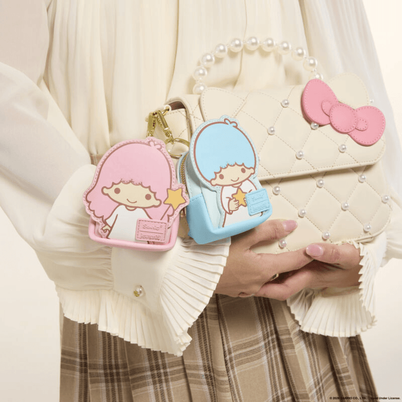 Loungefly Kiki and Lala mini backpack keychain charms attached to a Hello Kitty bag
