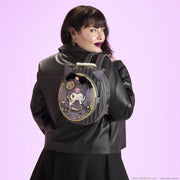 Model wearing Loungefly Kuromi Cameo mini backpack on back, showing round silhouette and ears.