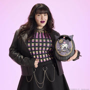 Model holding Loungefly Sanrio Kuromi Cameo mini backpack with pearl handle, studio shot.