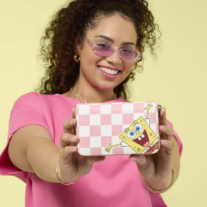 Model holding Loungefly SpongeBob and Patrick checkered wallet