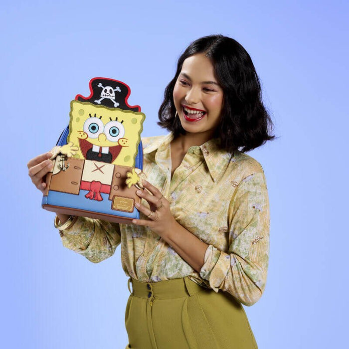 Model holding Loungefly SpongeBob pirate mini backpack with character face, pirate hat and costume details