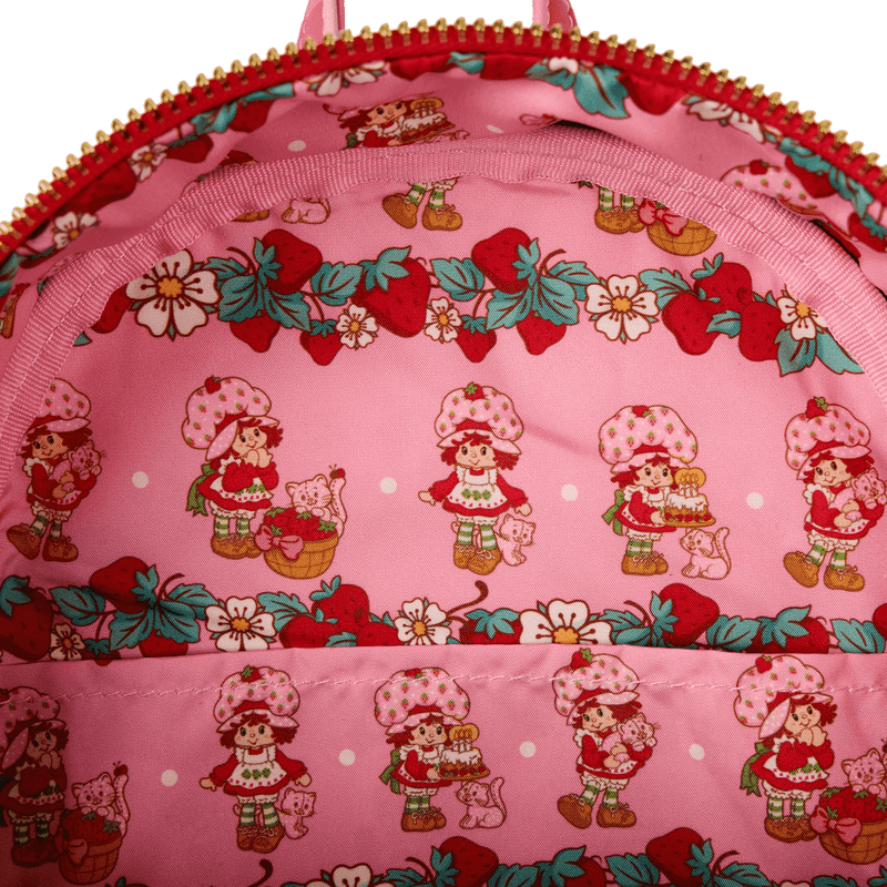 Close up of Strawberry Shortcake themed pink printed lining inside Loungefly faux denim mini backpack