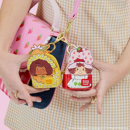 Loungefly Strawberry Shortcake mystery mini backpack charms styled on a bag