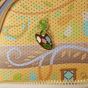 Pascal paint palette enamel pin on Loungefly Tangled pin trader backpack