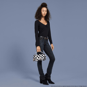 Model carrying the Loungefly Art the Clown Crossbody Bag