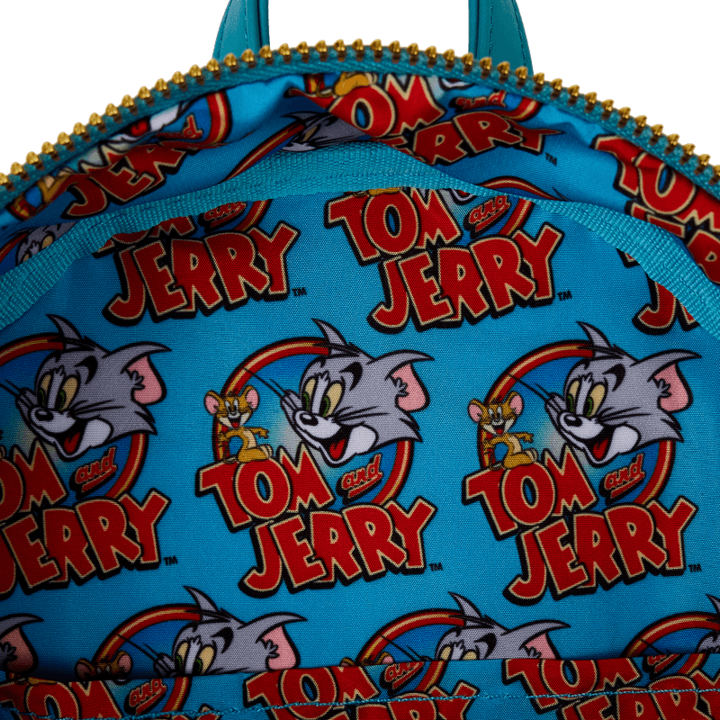 Interior close-up of Tom and Jerry logo print lining inside Loungefly mini backpack