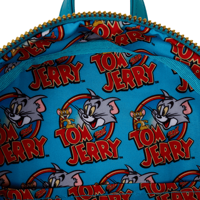 Interior close-up of Tom and Jerry logo print lining inside Loungefly mini backpack