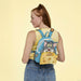 Model wearing Loungefly Tom and Jerry teal mini backpack with cheese pocket