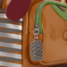 Close-up of Loungefly Toy Story Slinky Dog mini backpack molded metal slinky zipper charm