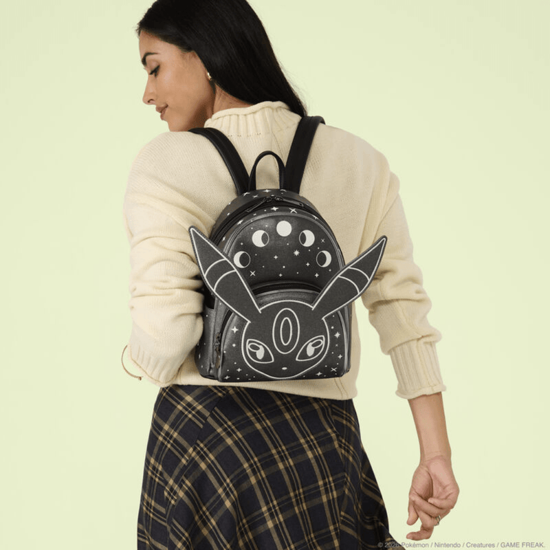 Model wearing Loungefly Pokémon Umbreon mini backpack with large character ears and celestial moon phase design
