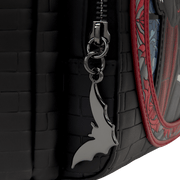 Close up of the Loungefly Universal Monsters Dracula mini backpack showing the molded metal bat zipper charm and black brick-effect texture
