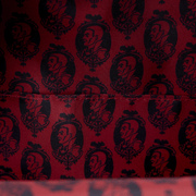 Interior lining of the Loungefly Universal Monsters Dracula mini backpack with red and black repeating Dracula portrait print
