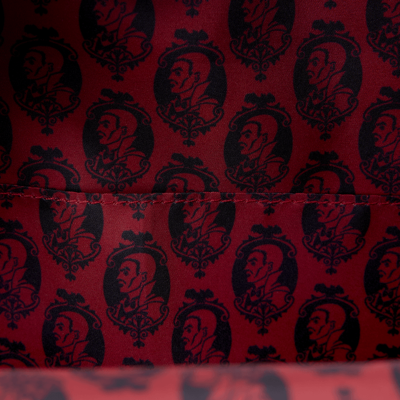Interior lining of the Loungefly Universal Monsters Dracula mini backpack with red and black repeating Dracula portrait print
