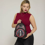 Model holding the Loungefly Universal Monsters Dracula Stained Glass Mini Backpack from the front
