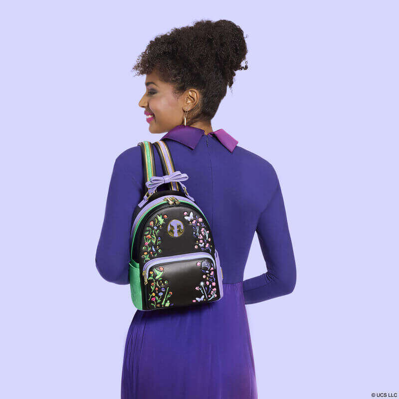 Model wearing the Loungefly Wicked Floral and Lace Mini Backpack showing the compact fit and embroidered front design
