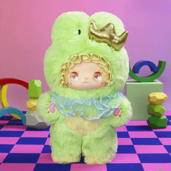 Matcha Grape plush – mint‑green frog suit with golden crown and frilly collar.

