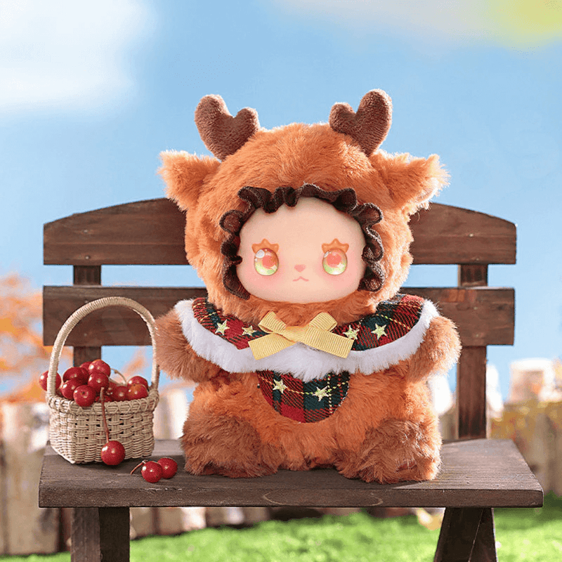 Star Elk plush mini, caramel deer costume with tartan scarf, sitting on bench
