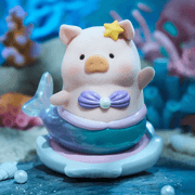 “Mermaid” LuLu with seashell bra and teal tail waving under-sea – Ocean Series Blind Box collectable
