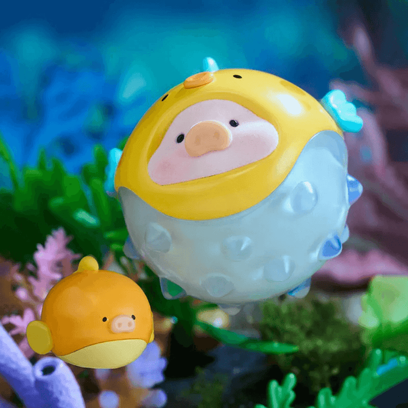 “Pufferfish” LuLu in yellow-blue inflatable suit drifting through coral – Ocean Blind Box collectable
