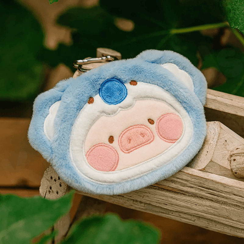 Koala Lu plush pouch in sky-blue fur; metal key clip visible behind the ears.
