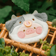 Close-up of Moo Lu plush pouch, Lulu the Piggy in a cow hood, showing embroidery and soft fur.
