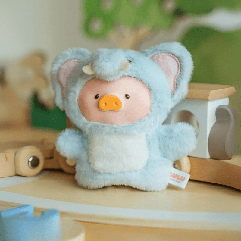 Lulu the Piggy Adorable Elephant plush keyring from blind box series, sky-blue costume posed on wooden nursery toys.
