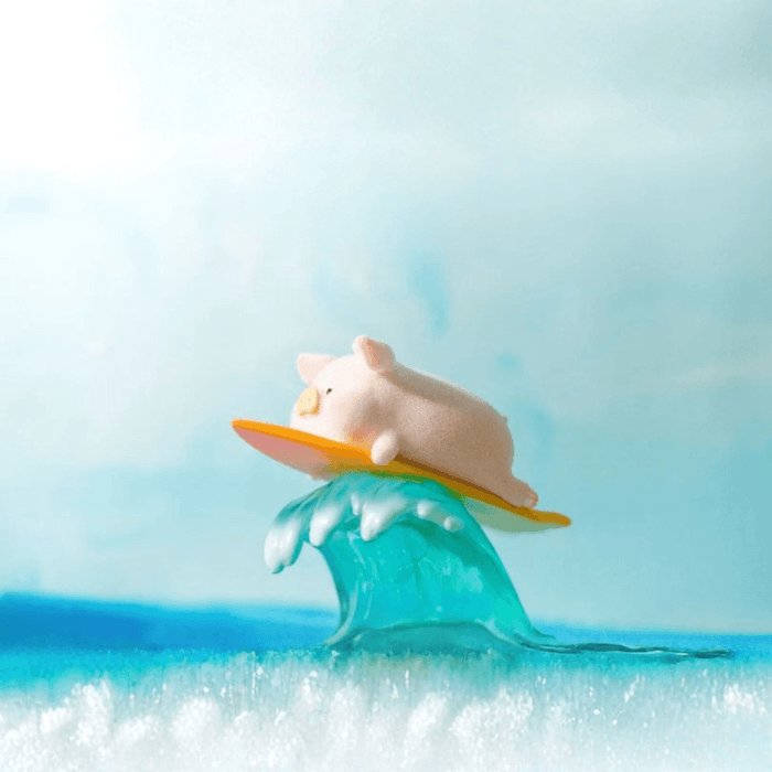 LuLu the Piggy Beach Party Blind Box Series Surf figure lying on a surfboard riding a blue wave