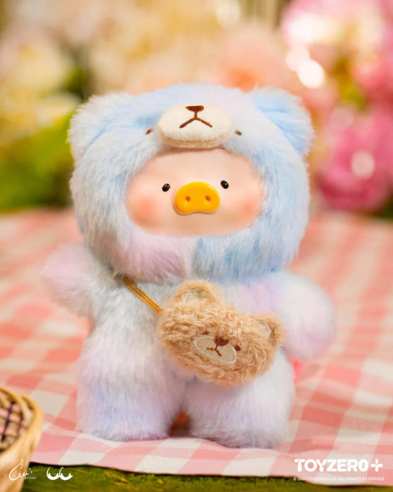 Lulu the Piggy Joyful Time blind box plush wearing a soft blue-gradient teddy suit and mini bear bag on a gingham picnic.
