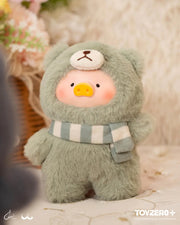 Lulu the Piggy Joyful Time blind box plush in sage-green teddy outfit with striped scarf, set against cosy floral décor.
