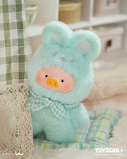 Lulu the Piggy Joyful Time blind box plush in mint bunny costume with gingham bow, peeking beside checked curtains.
