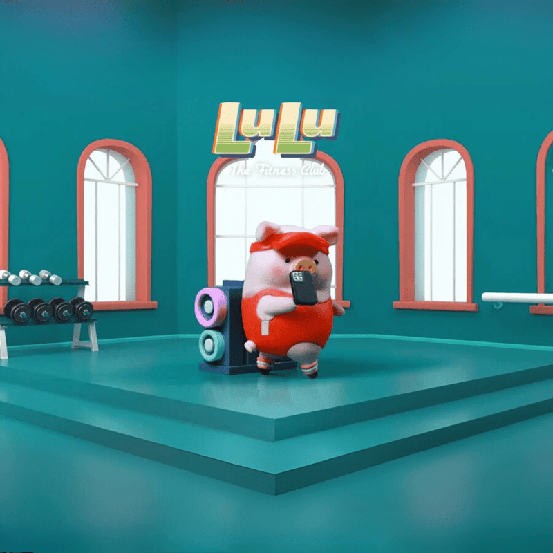 Lulu the Piggy Fitness Club Cardio Coach blind box figure in red tracksuit taking a phone-selfie beside pastel speakers on teal gym stage.
