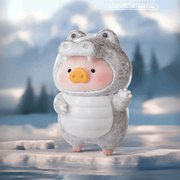 Lulu the Piggy Animal Party Rare-Colour / Special Grey Crocodile blind box figure waving from an icy lake scene, snowy mountains blurred behind.









