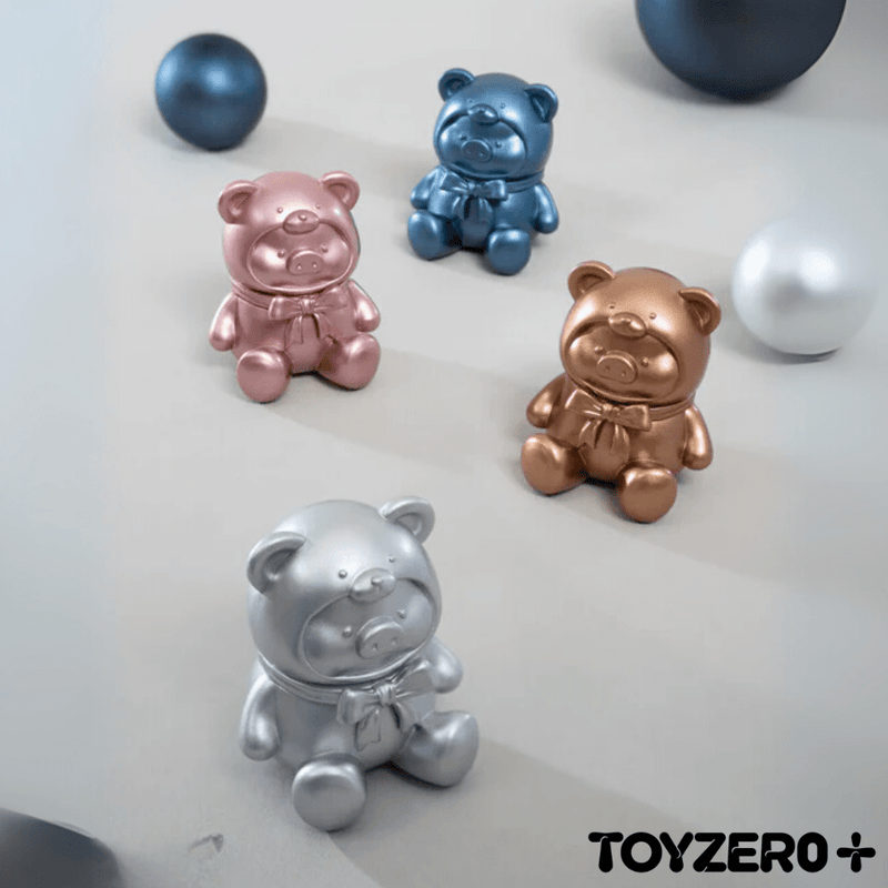 Lulu The Piggy metallic teddy figures in rose gold, silver, blue, and bronze finishes

