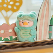 Lulu the Piggy Sentimental Crocodile blind box keyring, mint-green croc outfit beside pastel wooden scenery.
